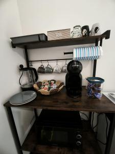 a table with a coffee maker and a microwave at Due Orizzonti in Monsampolo del Tronto