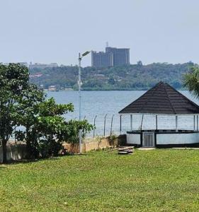 a gazebo in a field next to a body of water at Balmoral Palace Kisumu in Kisumu International Airport