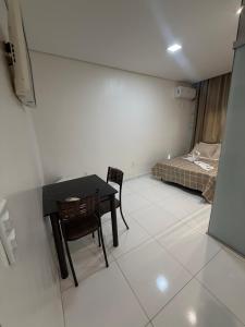 a room with a table and chairs and a bed at Pacheco Pousada in Sabará +14 photos