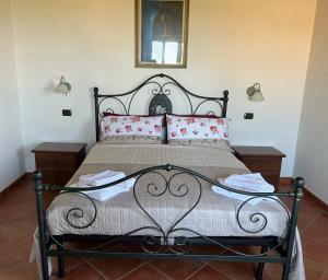 a bedroom with a large bed with red pillows at A casa di Leyla in Monteluro