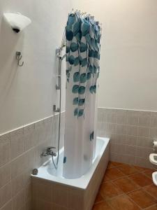 a shower curtain in a bath tub in a bathroom at A casa di Leyla in Monteluro +22 photos