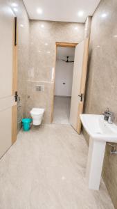 a bathroom with a sink and a toilet at Mountain top farmhouse in Gurgaon