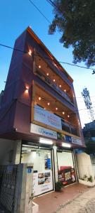 a building with a sign in front of it at COCHIN CINEMA Rooms in Cochin