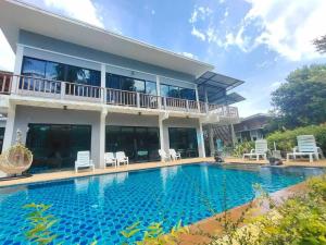 a house with a swimming pool in front of it at Phangpring Beach Resort in Ban Phang Pling
