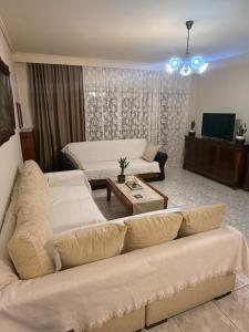a living room with a couch and a table at Velinora House in Rafina