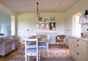 a kitchen and living room with a table and chairs at Costers Lodge in Midhurst