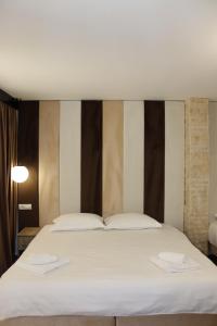 a bedroom with a large bed with two towels on it at La Brazi by BMD in Vulcan