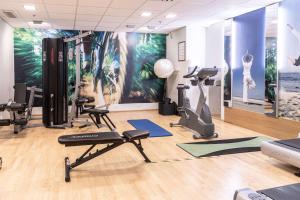 a gym with treadmills and exercise equipment in a room at Scandic Rosendahl in Tampere