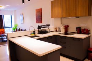 a kitchen with a sink and a counter top at Sky View Condo at Solaris in Christiansborg