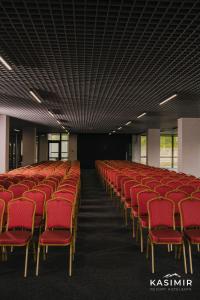 a row of red chairs in an empty room at Kasimir Hotel & SPA in Bukovel +110 photos