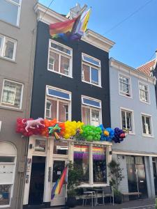 a store front with colorful balloons in front of a building at Amistad hotel in Amsterdam