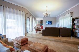 a living room with a couch and a table at Baleia Azul 24 in Ponta Mamoli
