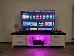 a large flat screen tv sitting on top of a dresser at Private bedroom in Shared Apartment in Hämeenlinna