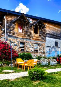 a house with a table and chairs in front of it at Vidikovac Uvac in Družiniće