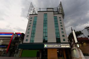 a tall building with a sign in front of it at Treebo Planet Mount Near US Consulate Anna Salai in Chennai