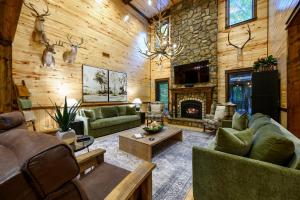 a large living room with a stone wall at Call It A Day Luxury Cabin in Stephens Gap