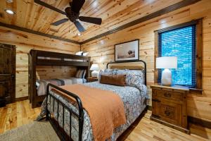 a bedroom with a bed and a ceiling fan at Call It A Day Luxury Cabin in Stephens Gap +53 photos