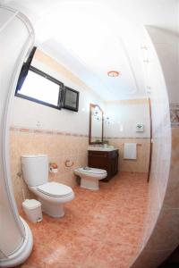 a bathroom with two toilets and a sink and a mirror at Verde Mar, vive el oceano en primera linea in La Santa +42 photos