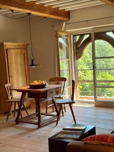 a living room with a table with a bowl of fruit on it at Das versteckte Nest in Seeon-Seebruck