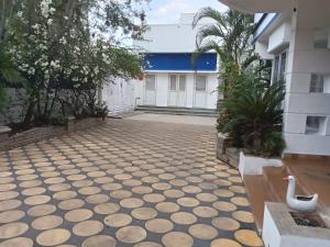 a courtyard of a building with a swan on the floor at Gurudeva stay inn in Covelong