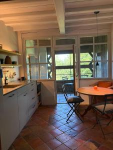 a kitchen with a table and a table and chairs at Das versteckte Nest in Seeon-Seebruck +32 photos
