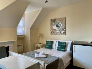 a bedroom with a bed with green and white pillows at Noa Residence in Oxford
