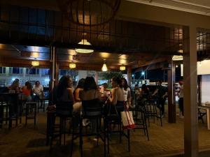 a group of people sitting at a restaurant at Nr 1 Spot in Paramaribo