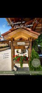 a sign for a gazebo with flowers in it at Chalet-Simmi in Wimmis