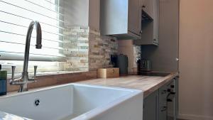 a kitchen with a white sink and a window at Downton I in Alnwick +32 photos