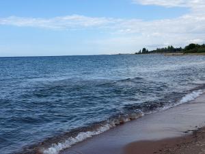 a body of water with a beach and the ocean at Atabek in Bosteri
