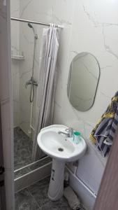a bathroom with a sink and a shower at Atabek in Bosteri