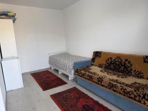 a living room with a couch and two rugs at Atabek in Bosteri