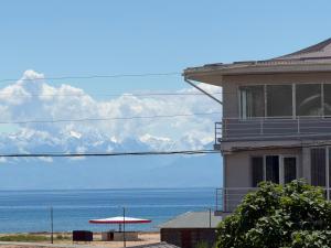 a building with a view of the ocean and mountains at Atabek in Bosteri