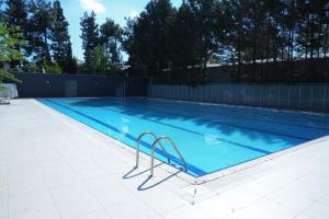 a large swimming pool with blue water at Karev Sport Hotel in Gümüşyaka