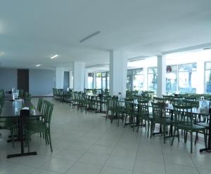 a dining room with tables and chairs and windows at Karev Sport Hotel in Gümüşyaka
