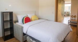a bedroom with a bed with two watermelons on it at Moderne Ferienwohnung im Bregenzerwald in Au im Bregenzerwald