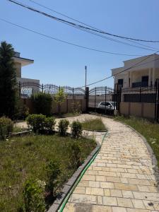 a brick walkway in front of a house at Prishtina Luxury House in Laplje Selo