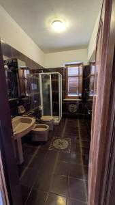 a bathroom with two toilets and a sink and a shower at Villa Sunrise in Casteldaccia +24 photos