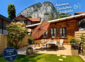 a patio with a table and chairs in front of a house at Chalet-Simmi in Wimmis +101 photos