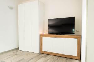 a living room with a tv on top of a cabinet at La Torre Guelfa in Iglesias