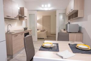 a kitchen with a table with two plates on it at La Torre Guelfa in Iglesias