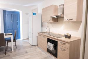a kitchen with a sink and a stove top oven at La Torre Guelfa in Iglesias