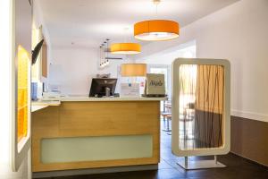 a kitchen with a counter and a mirror at ibis budget Narbonne Sud A9/A61 in Narbonne +31 photos