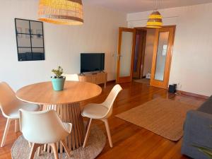 a living room with a table and chairs at Casa do Pirata by GuestPro in Matosinhos