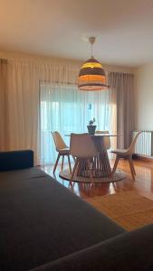 a living room with a table and chairs and a bed at Casa do Pirata by GuestPro in Matosinhos