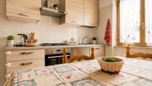 a kitchen with a table with a table cloth on it at La Tana della Volpe in Tempera