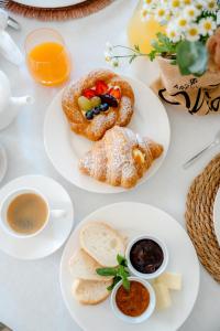 a white table with plates of food and drinks at Agriturismo Costa Arènte in Grezzana
