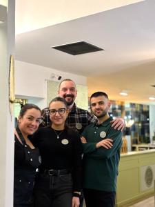 a group of people posing for a picture in a kitchen at BioBenessere Eco-B&B -Adults Only- Moto&Bike Parking in Arezzo