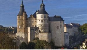 a large castle with turrets on a hill at Chez Alice 2 in Montbéliard