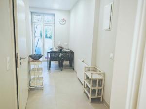 a hallway with a table and a dining room at Chez Alice 2 in Montbéliard +18 photos